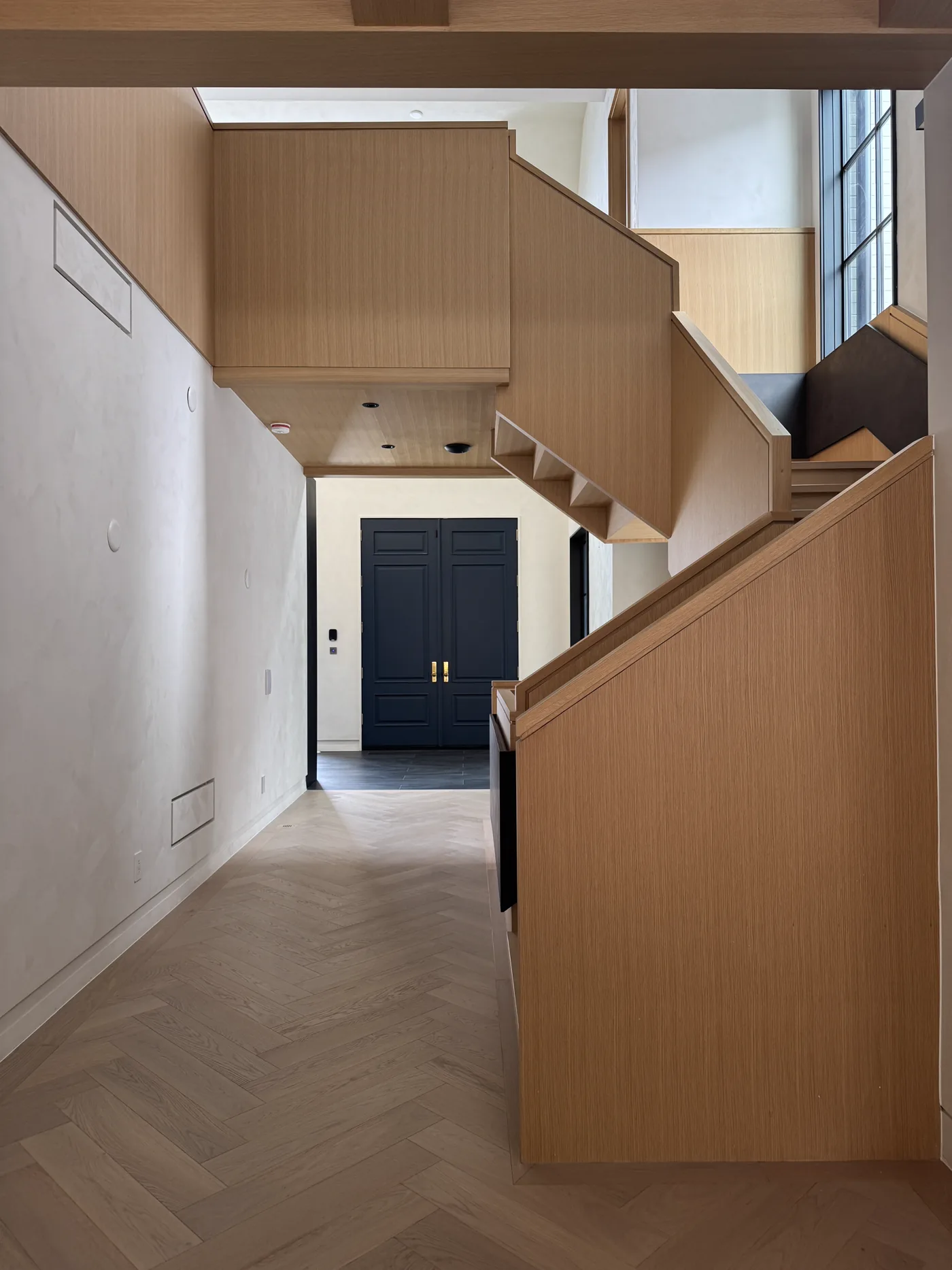 Rushworth entry hall with custom oak staircase and limewash walls